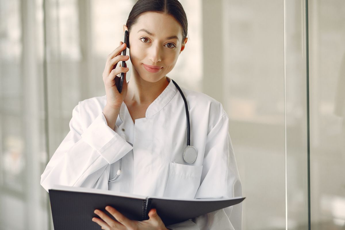 Healthcare professional speaking on the phone in a clinic