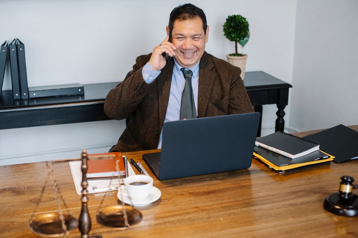 Legal professional speaking on the phone in an office